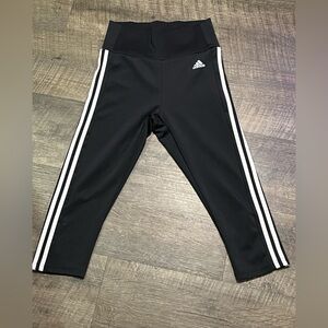Adidas Women’s Black Capri with 2 white stripes down the side.